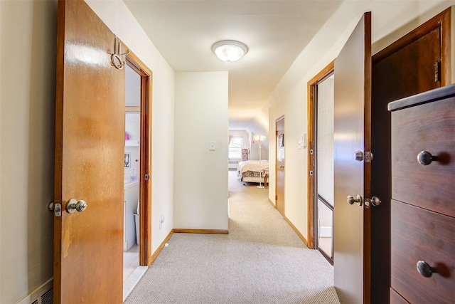 hall featuring light colored carpet