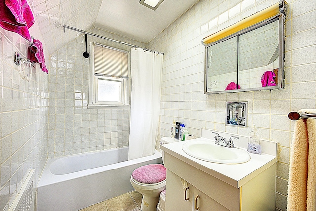 full bathroom featuring toilet, tile patterned flooring, tile walls, shower / bath combo, and vanity