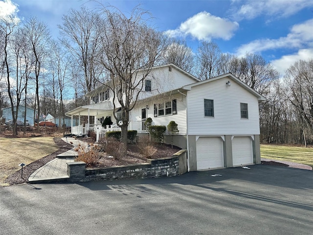 view of front facade with a garage and covered porch