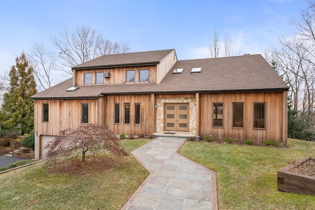 view of front of property with a front lawn and a garage