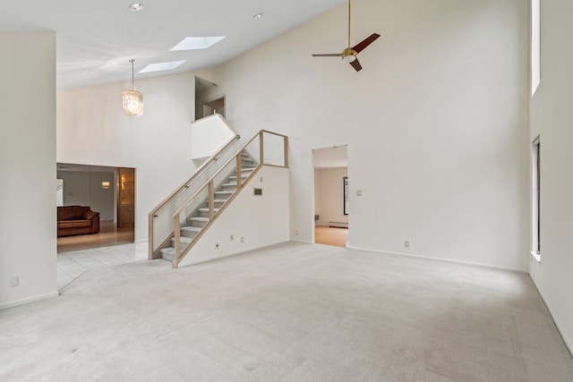 unfurnished living room featuring ceiling fan, light colored carpet, high vaulted ceiling, and a baseboard heating unit