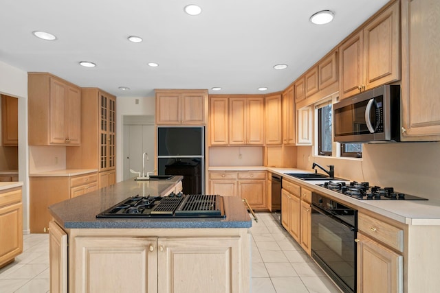 kitchen featuring a kitchen island, light tile patterned floors, black appliances, and light brown cabinets