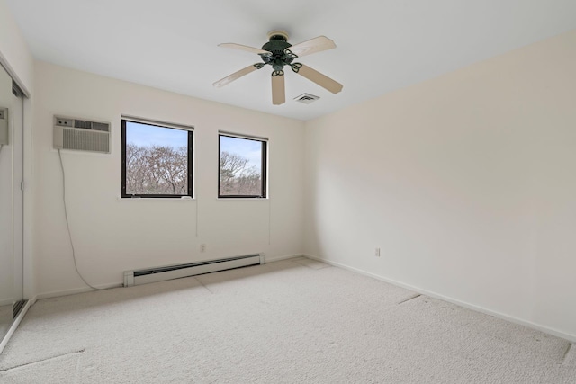 carpeted spare room with ceiling fan, a baseboard radiator, and a wall mounted air conditioner