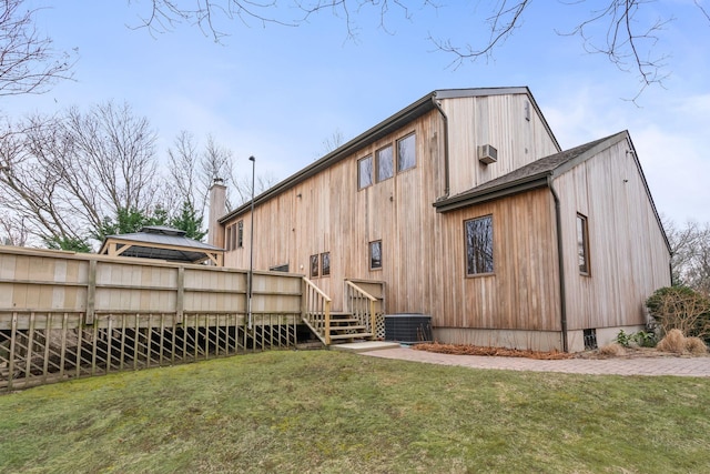 back of house with a lawn, central AC, a deck, and a gazebo