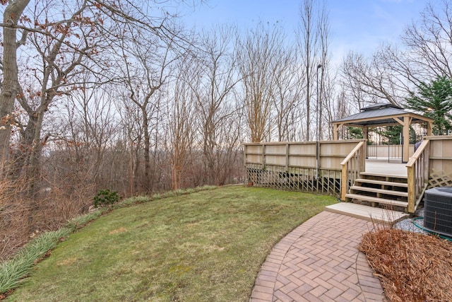 view of yard with central AC and a gazebo