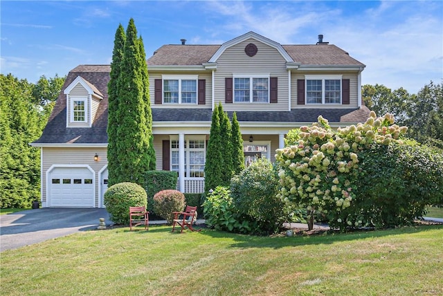 view of front of house featuring a front yard and a garage