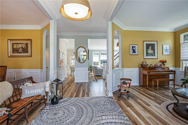 foyer with ornamental molding and wood-type flooring