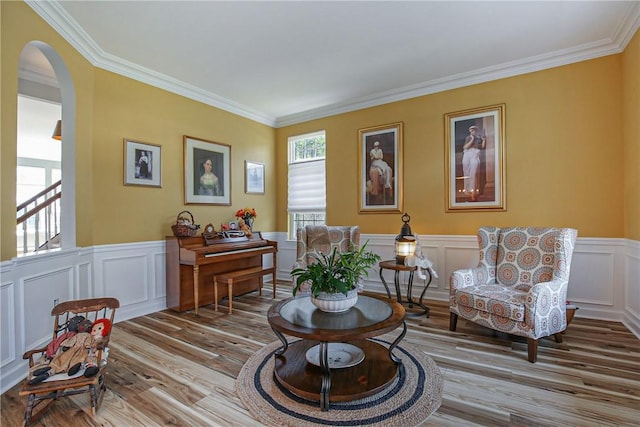 sitting room featuring light hardwood / wood-style flooring and crown molding