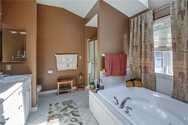 bathroom with lofted ceiling, tile patterned flooring, vanity, and tiled bath