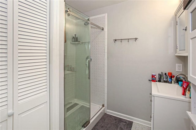 bathroom featuring walk in shower and vanity