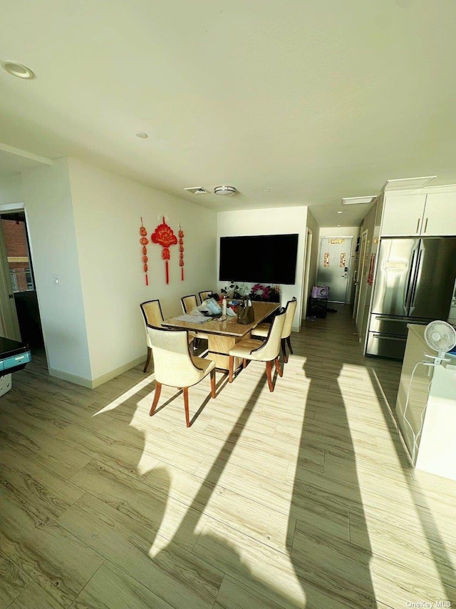 dining room with light hardwood / wood-style flooring