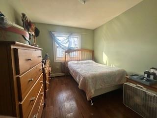 bedroom with dark hardwood / wood-style flooring