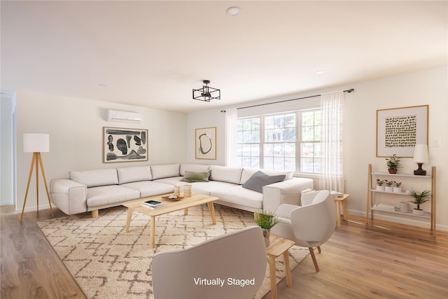 living room with a wall mounted AC and hardwood / wood-style floors