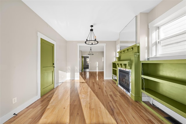 unfurnished living room with a fireplace and light hardwood / wood-style floors