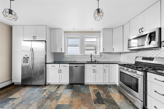 kitchen with sink, appliances with stainless steel finishes, pendant lighting, and white cabinetry