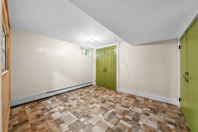 empty room with a baseboard radiator and light parquet floors