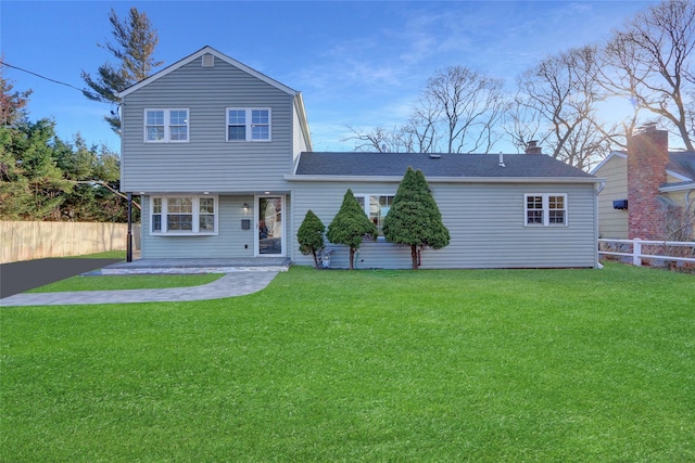 back of house with a lawn