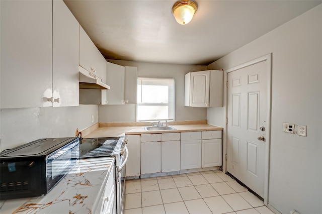 kitchen featuring sink and white cabinets