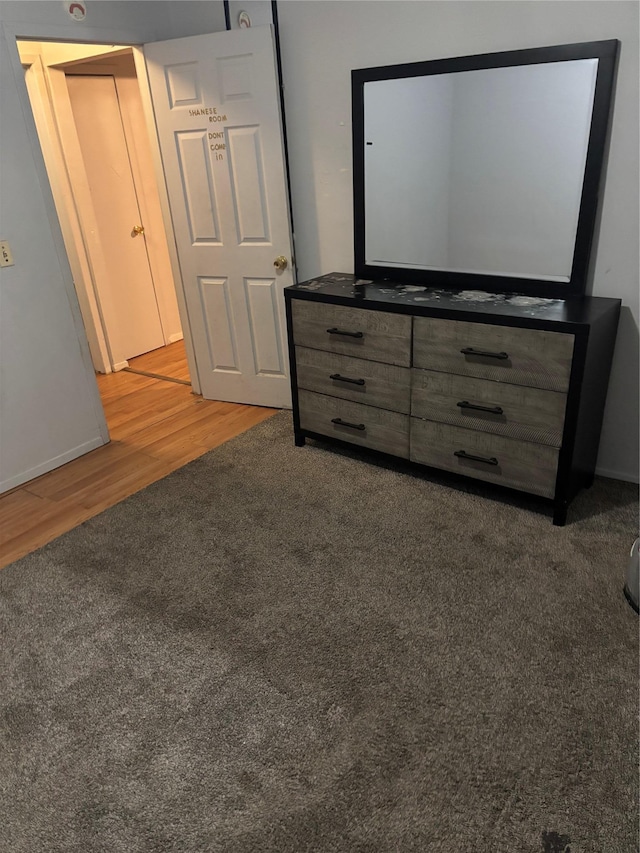 unfurnished bedroom featuring dark carpet