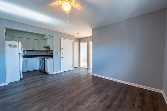 interior space with white fridge, ceiling fan, decorative backsplash, dark hardwood / wood-style flooring, and stainless steel range with gas stovetop