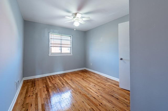 empty room with ceiling fan and light hardwood / wood-style floors