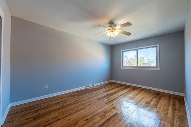 spare room featuring ceiling fan and hardwood / wood-style floors