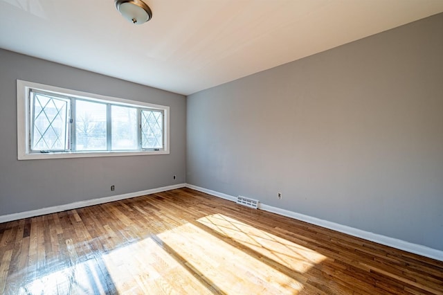 empty room with light hardwood / wood-style flooring