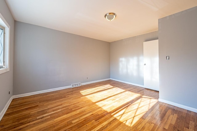 empty room with hardwood / wood-style flooring