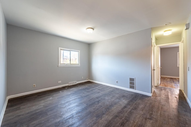 spare room with dark hardwood / wood-style floors