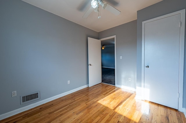 unfurnished bedroom with ceiling fan and light hardwood / wood-style flooring