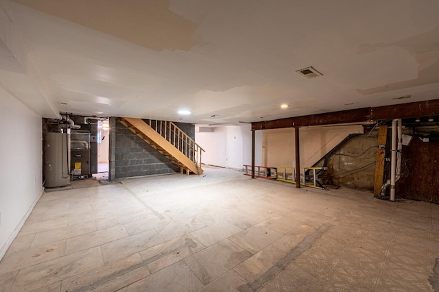 basement featuring gas water heater and heating unit