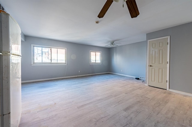 empty room with ceiling fan and light wood-type flooring