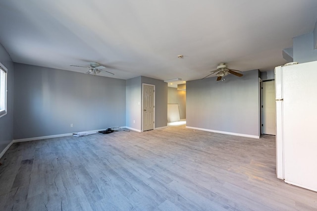 unfurnished room featuring ceiling fan and light hardwood / wood-style floors