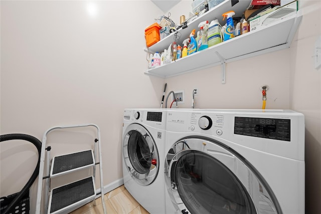 laundry area with independent washer and dryer and light tile patterned flooring