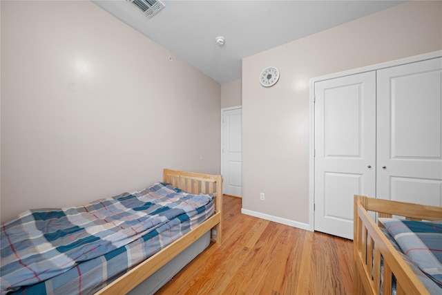 bedroom featuring a closet and light hardwood / wood-style flooring