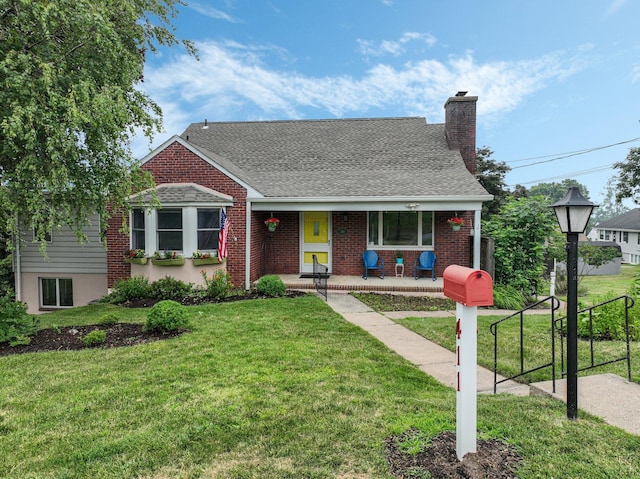 view of front of house featuring covered porch and a front lawn