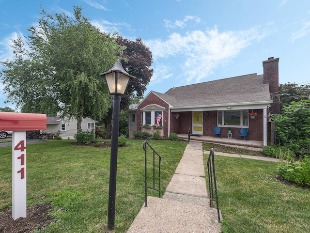 view of front of property with covered porch and a front yard