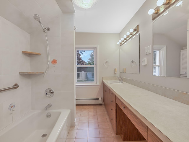 bathroom featuring baseboard heating, tile patterned floors, tiled shower / bath combo, and vanity