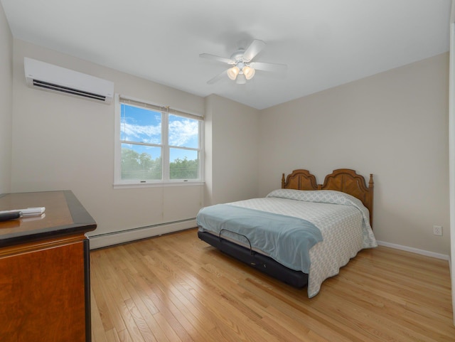 bedroom with ceiling fan, baseboard heating, light wood-type flooring, and a wall mounted air conditioner