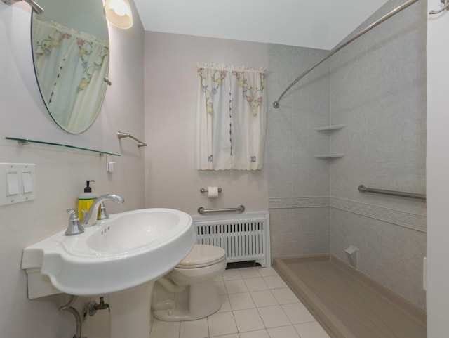 bathroom featuring toilet, tile patterned floors, walk in shower, and radiator heating unit