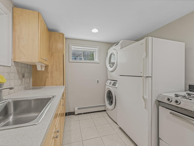 interior space featuring stacked washer and clothes dryer, light tile patterned floors, sink, and a baseboard heating unit