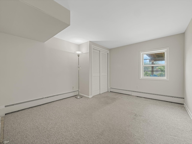 bonus room with light colored carpet and a baseboard heating unit