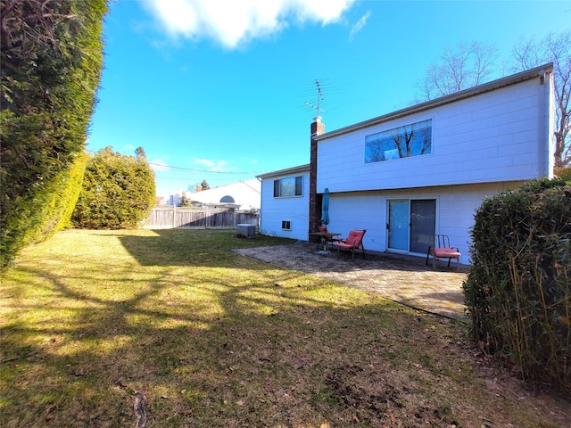 rear view of property with a patio area and a yard