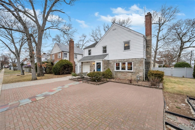 view of front of house with a garage and a front yard