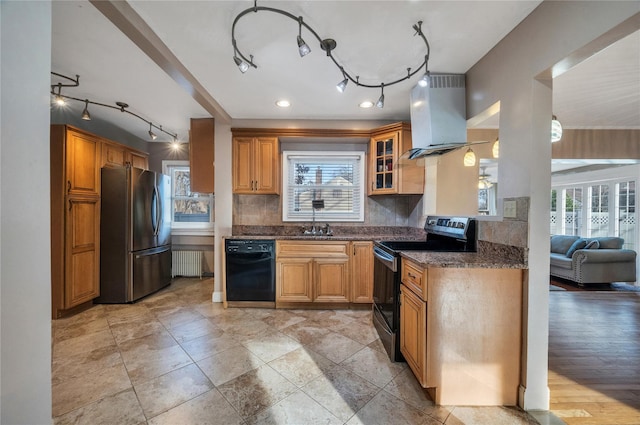 kitchen with island range hood, a healthy amount of sunlight, and appliances with stainless steel finishes