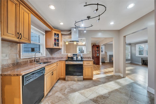 kitchen featuring stone countertops, black dishwasher, sink, island exhaust hood, and electric stove