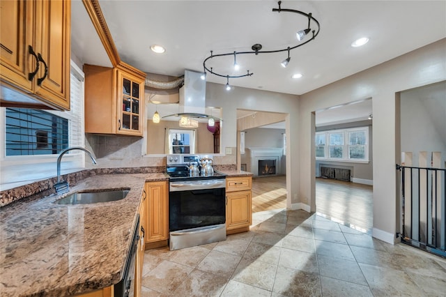 kitchen with sink, backsplash, stainless steel range with electric stovetop, island exhaust hood, and light stone counters