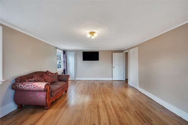 sitting room featuring ornamental molding and light wood-type flooring