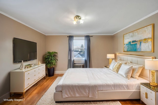 bedroom featuring ornamental molding and light wood-type flooring