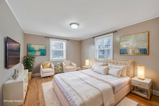 bedroom featuring ornamental molding and light hardwood / wood-style flooring